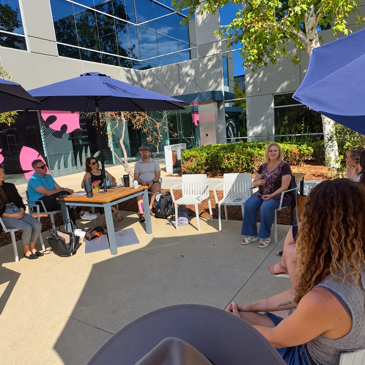 Small group seated in an outdoor circle in conversation